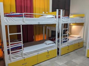 a room with two bunk beds in a room at The Desire Hostel in New Delhi