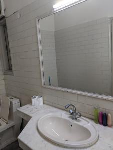 a bathroom with a sink and a mirror at The Desire Hostel in New Delhi