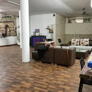 a living room with couches and a couch and a table at The Desire Hostel in New Delhi