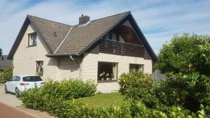 a white house with a black roof at Ferienwohnung Holzberger in Goslar