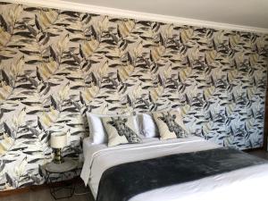 a bedroom with a bed with a floral wallpaper at Number Six in Durban