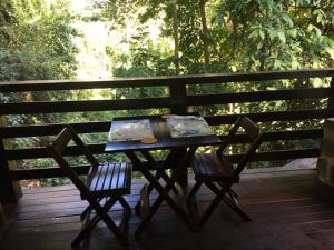 a picnic table and two chairs on a deck at Casa Pedra Bonita in Rio de Janeiro