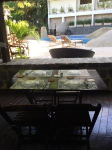 a table with plates on it on a patio at Casa Pedra Bonita in Rio de Janeiro