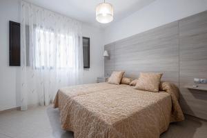 Giường trong phòng chung tại Apartamentos San Pedro +14 ảnh
