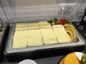 a tray of cheese and fruits and vegetables in a refrigerator at Kappl Apart in Kappl