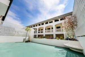 a swimming pool in front of a building at Maleewan Jomtien in Jomtien Beach