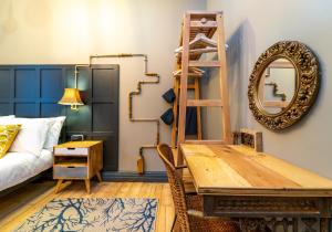 a room with a bed and a table and a mirror at The Waverley Park Residence in Edinburgh