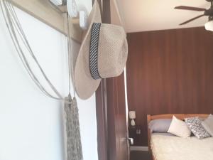 a bedroom with a bed and a window with a fan at La Estacion Colonia in Colonia del Sacramento