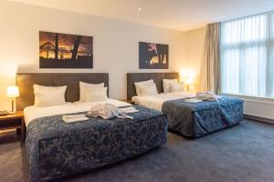 Un pat sau paturi într-o cameră la De Zwaan Delden