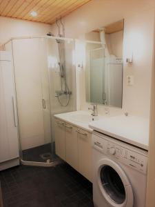 a bathroom with a washing machine and a sink at Ylläs Chalet 8208 in Ylläs