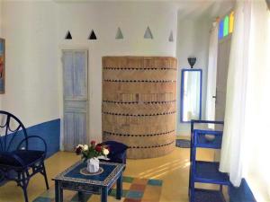 a living room with a table and a barrel at Riad Haizea Mogador in Essaouira
