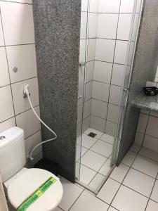 a bathroom with a toilet and a glass shower at Hotel Cabana in Teresina