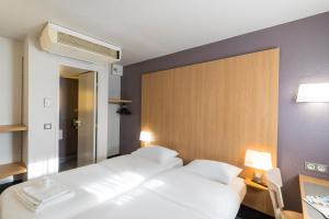 Postel nebo postele na pokoji v ubytování B&B HOTEL Auxerre Bourgogne