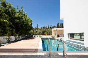 a swimming pool in a backyard with a house at Down Town Villa Kato Paphos in Paphos City