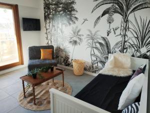 a living room with a couch and a chair at Appartement Coup de Coeur avec Parking et Piscine - 131 in Canet-en-Roussillon