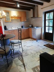 a kitchen with wooden cabinets and a table and chairs at Stargazer Studio in Saint-Chamassy