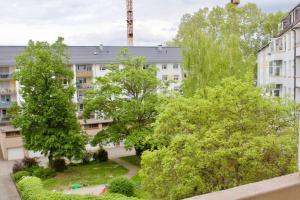 an apartment building with trees in front of it at Fantastic Apartment in Enchanting Neighbourhood in Ludwigshafen am Rhein