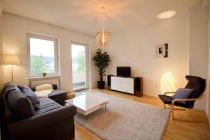 a living room with a couch and a table at Fantastic Apartment in Enchanting Neighbourhood in Ludwigshafen am Rhein