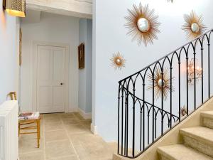 a hallway with stairs with gold and white walls at Le Clos Saluces in Avignon
