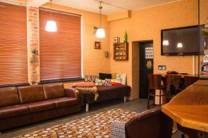 a living room with a couch and a tv at Studio Apartment Lahti in Lahti