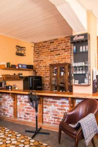 a bar in a restaurant with a brick wall at Studio Apartment Lahti in Lahti
