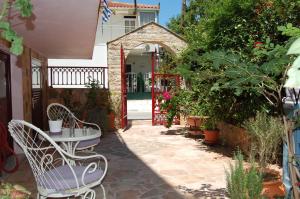 a patio with a table and chairs and plants at Alkyoni Apartments & Studios in Poros +23 photos