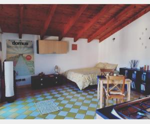 a bedroom with a bed and a table in a room at Casetta Gialla in Giaveno