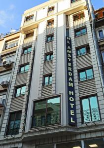 um edifício com um sinal na lateral em NL Amsterdam Hotel em Istambul