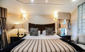 a bedroom with a large bed with two zebra pillows at Hardwick Hall Hotel in Sedgefield