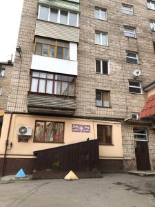 a large brick building with a balcony on it at LUXflats Rivne in Rivne