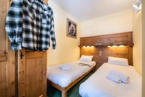 Postel nebo postele na pokoji v ubytování Le Cheval Blanc - Village Montana