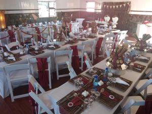 a group of tables and chairs in a room at Twilight Breeze Lodge in Phuthaditjhaba