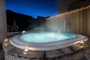 a jacuzzi tub with a water fountain at Hotel La Fradora - Dolomites Hotel in San Cassiano