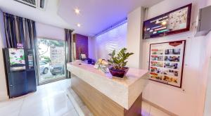 a bar in a restaurant with a plant on a counter at Carlton Hotel in Sliema