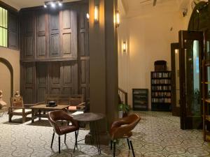 a room with two chairs and a table and a table and chairs at The J Break Boutique in Kampot