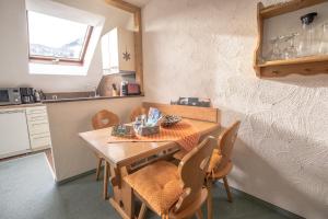 a kitchen with a table and chairs in a room at Ferienwohnung Auszeit in Bad Hindelang