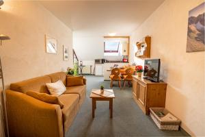 a living room with a couch and a table at Ferienwohnung Auszeit in Bad Hindelang