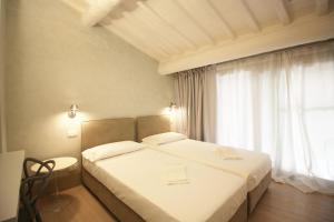 מיטה או מיטות בחדר ב-La Loggia Cortonese