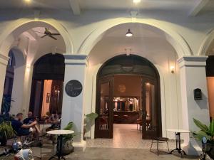 a group of people sitting at tables in a building at The J Break Boutique in Kampot