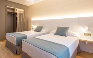 Posteľ alebo postele v izbe v ubytovaní Hotel Olympia Valencia