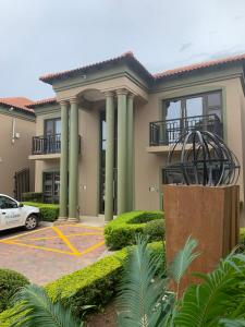 a house with a car parked in front of it at Royal Hotel in Polokwane