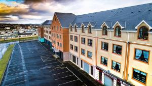 an overhead view of a building with a parking lot at Luxury Penthouse Apartment overlooking Main Beach in Bundoran
