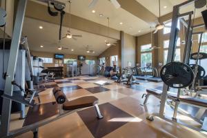 a gym with several treadmills and machines in a room at Resort Style Apartment/Home - The Woodlands in The Woodlands