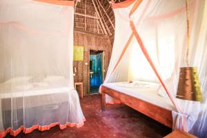 a room with two beds and a window at Your Zanzibar Place in Paje