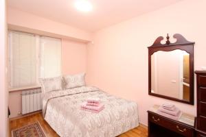A bed or beds in a room at Top Apartments - Yerevan Centre