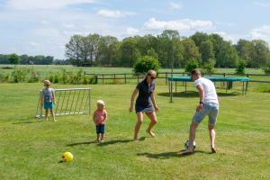 a group of people playing soccer in a field at de Huttert Opkamer in Luttenberg