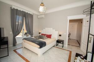Ένα ή περισσότερα κρεβάτια σε δωμάτιο στο Compasso Suites