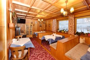 a restaurant with two tables in a room at Pension Piz Buin in Partenen
