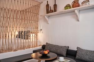 a living room with a couch and a table at Almyra Guest Houses in Paraga