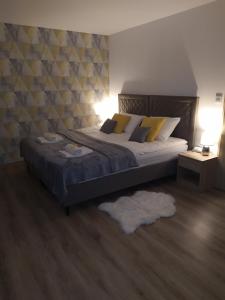 a bedroom with a large bed with yellow pillows at Apartament KAOLA in Jelenia Góra